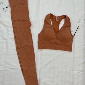 New with tags ribbed leggings/sports bra set. size L. Rust/Burnt orange color.